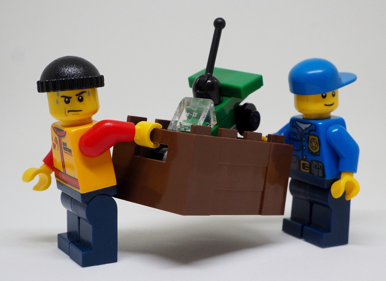 Cover Image: Two Lego Figures Carrying Tools, Working Together